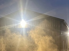 A wall pack shining through dust and debris